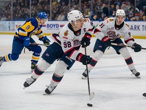 Regina Pats forward Connor Bedard (98) skates with the puck during the second period of WHL playoff hockey action against the Saskatoon Blades in Saskatoon, Sask., on Friday, March 31, 2023.