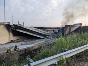 In this handout photo provided by the City of Philadelphia Office of Emergency Management, smoke rises from a collapsed section of the I-95 highway