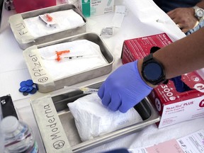 Syringes with vaccines are prepared at the L.A. Care and Blue Shield of California Promise Health Plans' Community Resource Center