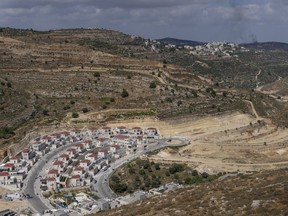This file photo shows a part of new housing projects in the West Bank Israeli settlement of Givat Ze'ev, Monday, June 18, 2023.