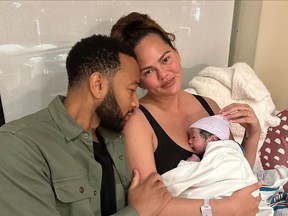 John Legend and Chrissy Teigen are pictured with their fourth child in a photo