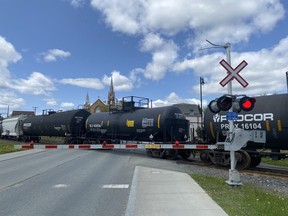A DOT111 train car, centre, transports hazardous materials, also called "dangerous goods," in downtown Lac-Megantic