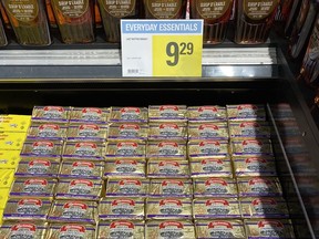 Fridge case of butter in grocery store.