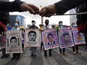 Relatives and classmates of the missing 43 Ayotzinapa college students march