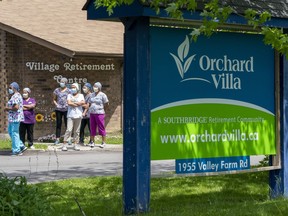 Workers watch as nursing union members show their support at the Orchard Villa Long-Term Care in Pickering, Ont. on Monday June 1, 2020.