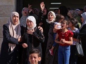 Palestinians react during the funeral of Tareq Erdis