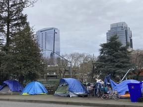 People camp in tents next to the Interstate in Portland