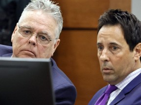 Former Marjory Stoneman Douglas High School School Resource Officer Scot Peterson, left, and defense attorney Mark Eiglarsh watch a video of the shooting during his trial, Thursday, June 8, 2023, at the Broward County Courthouse in Fort Lauderdale, Fla. Peterson is charged with child neglect and other charges for failing to stop the Parkland school massacre five years ago. (Amy Beth Bennett/South Florida Sun-Sentinel via AP, Pool)