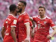 FILE - Bayern's Serge Gnabry, left, celebrates besides team mate Bayern's Noussair Mazraoui and Bayern's Thomas Mueller after scoring his side's opening goal during the German Bundesliga soccer match between FC Bayern Munich and Hertha BSC Berlin at the Allianz Arena stadium in Munich, Germany, on April 30, 2023. Bayern Munich and Qatar Airways said Wednesday June 28, 2023 they are ending a sponsorship deal which caused tension between the German soccer champion and its fans.