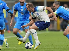 FILE - England's Harry Kane, center, wearing a rainbow armband, controls the ball during the UEFA Nations League soccer match between Italy and England at the San Siro stadium, in Milan, Italy, on Sept. 23, 2022. The anti-discrimination "One Love" captain's armband controversially denied to teams at the men's World Cup in Qatar will be worn at the Women's World Cup next month in an amended version now approved by FIFA. FIFA has unveiled eight campaign armbands on Friday, June 30, 2023.