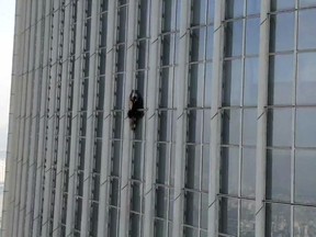 This photo provided by the Seoul Metropolitan Fire and Disaster Management Headquarters, shows an unidentified British man climbing Lotte World Tower, the tallest skyscraper in the country, in Seoul, South Korea, Monday, June 12, 2023.