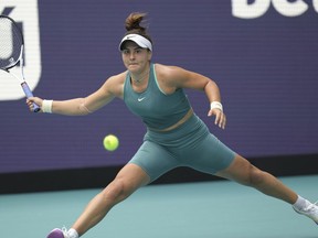 Bianca Andreescu, of Canada, returns a volley from Emma Raducanu, of Great Britain, in the first set of a match at the Miami Open tennis tournament, Wednesday, March 22, 2023, in Miami Gardens, Fla.