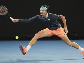Canada's Milos Raonic hits a forehand return to Serbia's Novak Djokovic during their fourth round match at the Australian Open tennis championship in Melbourne, Australia, Sunday, Feb. 14, 2021.Raonic defeated Serbia's Miomir Kecmanovic 6-3, 6-4 at the Libema Open for his first ATP Tour match victory in nearly two years.THE CANADIAN PRESS/AP/Hamish Blair