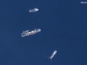 In this satellite image provided by Maxar Technologies, from top to bottom, the vessels Horizon Arctic, Deep Energy and Skandi Vinland