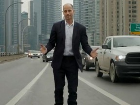 Man in suit roller-blading on traffic-filled highway