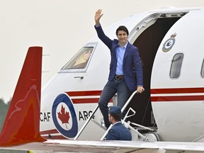 Prime Minister Justin Trudeau waves as he steps off a plane, Wednesday, June 14, 2023 at CFB Bagotville