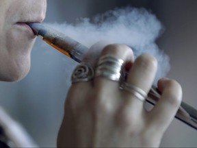 A woman uses an electronic cigarette