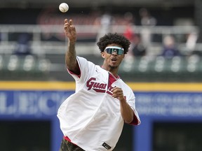 Cleveland Browns cornerback Greg Newsome II throws out a ceremonial first pitch before a baseball game between the Chicago White Sox and the Cleveland Guardians, Monday, May 22, 2023, in Cleveland.