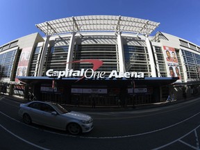 FILE - An exterior view of Capital One Arena is seen Saturday, March 16, 2019, in Washington. Capital One Arena is home to the Washington Capitals NHL hockey team and Washington Wizards NBA basketball team. A person with knowledge of the sale tells The Associated Press the Qatar Investment Authority is buying a 5% stake of the parent company of the NBA's Washington Wizards and NHL's Washington Capitals for $4.05 billion. It is believed to be the first time the government of Qatar is investing in North American professional sports.