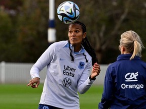 French women's football captain Wendie Renard heads the ball during a training session.