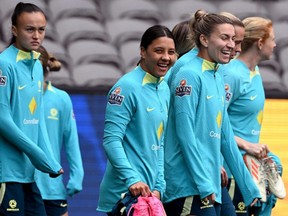 Australia's women's football captain Sam Kerr (C) and her teammates walk during a training session.