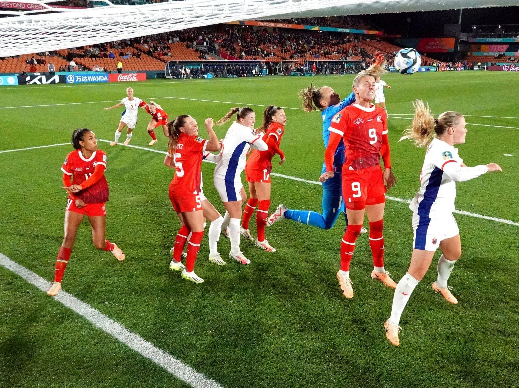 Gaelle Thalmann and Ana-Maria Crnogorcevic of Switzerland attempt to clear the ball.