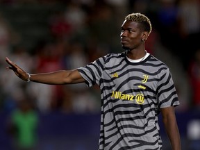 Paul Pogba of Juventus waves as he leaves the field during the Pre-Season Friendly match between Juventus and AC Milan.