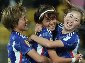 Japan's Hinata Miyazawa (C) celebrates with her teammates after scoring her team's third goal against Spain.