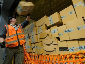 A worker loads a truck with packages