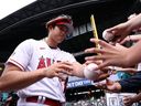 Shohei Ohtani of the Los Angeles Angels signs autographs during Gatorade All-Star Practice Day at T-Mobile Park on Monday, July 10, 2023 in Seattle. 