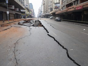 A general view of a damaged road in Johannesburg on July 20, 2023, following an unexplained explosion which occurred during rush hour on July 19, 2023.
