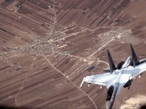 In this image from video released by the U.S. Air Force, a Russian SU-35 flies near a U.S. Air Force MQ-9 Reaper drone on Wednesday, July 5, 2023, over Syria.