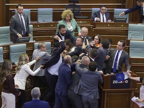 Lawmakers push each other as a brawl breaks out in Kosovo's parliament in Pristina, Kosovo