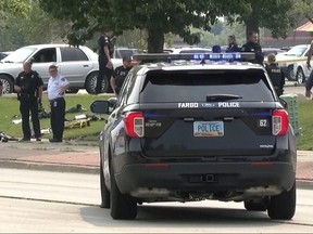 In this image from video, law enforcement officers work at the scene of a shooting Friday, July 14, 2023, in Fargo, N.D.