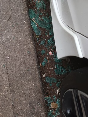 Broken glass at a car door. Vehicle break-ins are common near the harm reduction sites.