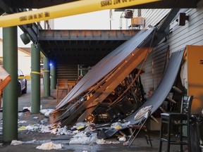 Police tape is wrapped around the scene of a deck collapse at Briarwood Country Club in Billings, Mont., Sunday, July 23, 2023.