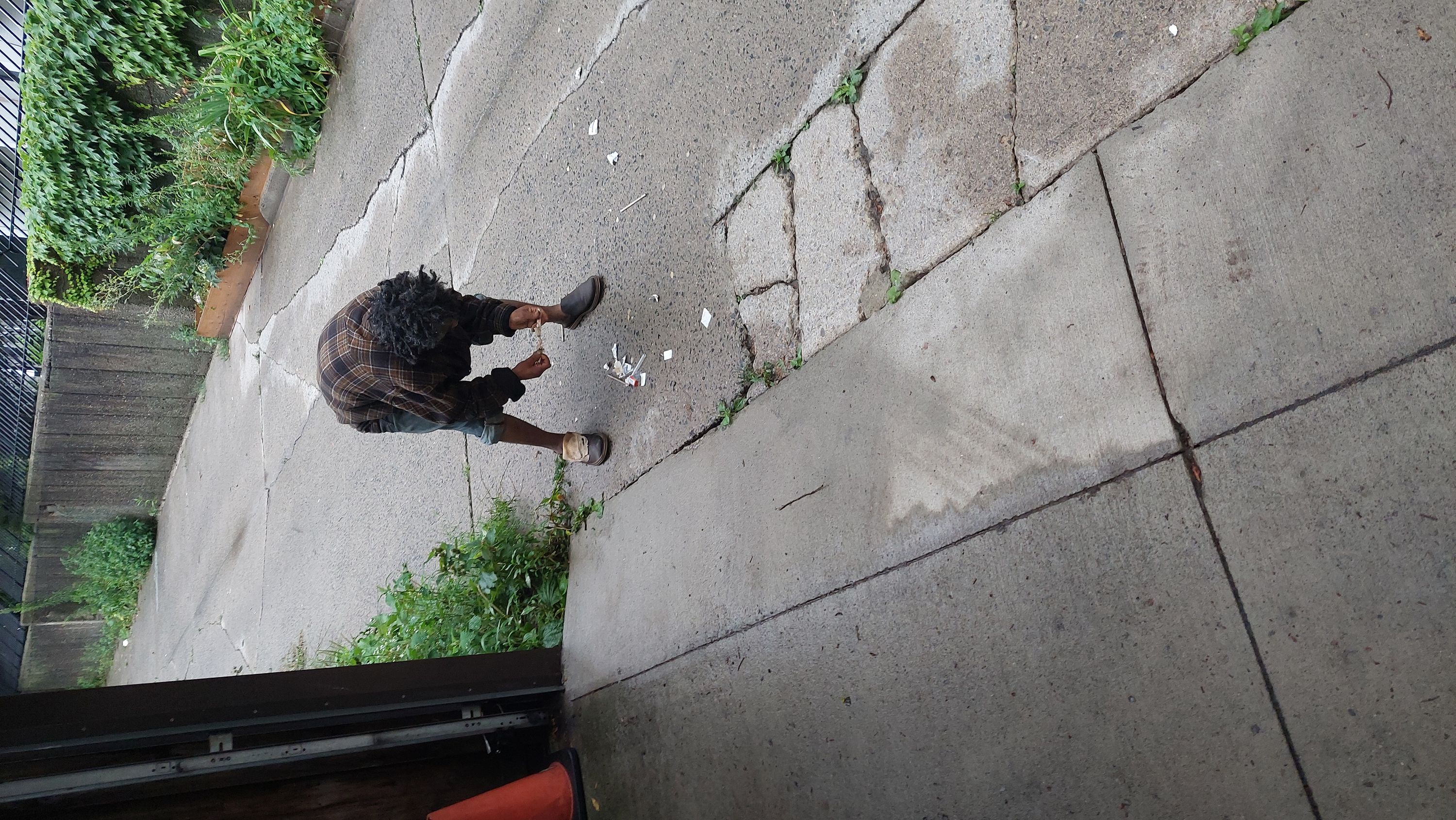 Distraught man fumbles with his drug paraphernalia in Toronto's Moss Park area.