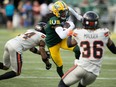 The Edmonton Elks' Steven Dunbar Jr. (7) battles the B.C. Lions' Marcus Sayles (14) and Quincy Mauger (36) during first half CFL action at Commonwealth Stadium, in Edmonton Saturday July 29, 2023.