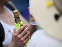 A tennis fan drinks Champagne on the sixth day of the 2023 Wimbledon Championships at the All England Club in Wimbledon, England, on Saturday, July 8, 2023.