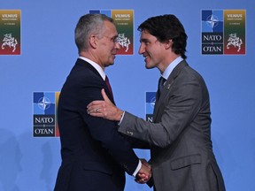 NATO Secretary-General Jens Stoltenberg greets Prime Minister Justin Trudeau.