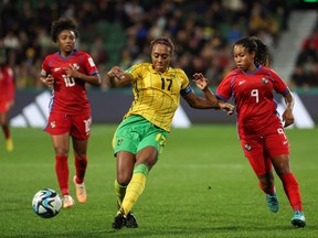 Jamaica's defender Allyson Swaby (centre) and Panama's forward Karla Riley (right) fight for the ball