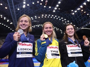 Left to right: Silver medallist Katie Ledecky of Team United States, gold medallist Ariarne Titmus of Team Australia and bronze medallist Erika Fairweather of Team New Zealand pose during the medal ceremony