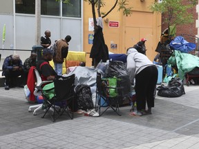 Refugees camped outside of homeless shelter