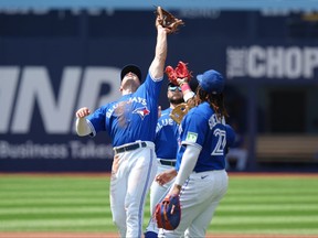 Toronto Blue Jays third baseman Matt Chapman reaches to catch a pop-up.