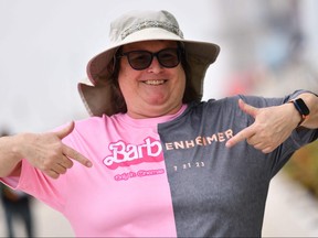 An attendee points at her Barbenheimer shirt outside the convention center during San Diego Comic-Con International in San Diego, Calif., on July 20, 2023.