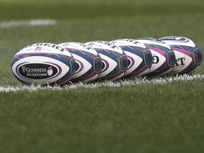 FILE - Rugby balls are lined up on the pitch prior to the start of the rugby union international match between Scotland and Italy at the Murrayfield stadium in Edinburgh, Scotland, on March 20, 2021.