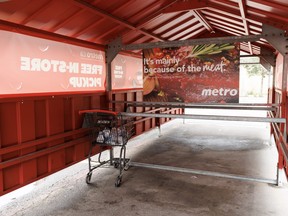 A lone shopping cart is seen outside a Metro grocery store in Toronto