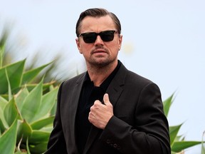 Leonardo DiCaprio wearing sunglasses, leaving photocall at Cannes Film Festival