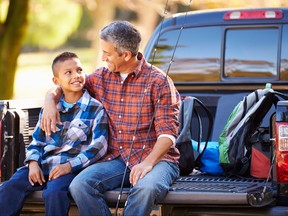 Father And Son Sitting In Pick Up Truck