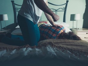 Man abusing his wife on a bed